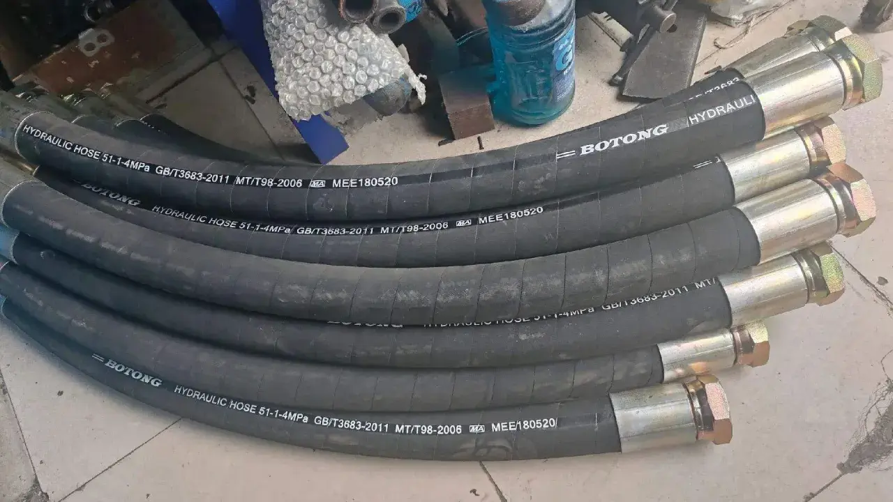 Plusieurs tuyaux hydrauliques BOTONG, chaque tuyau serti avec des raccords métalliques, prêts pour l'installation.