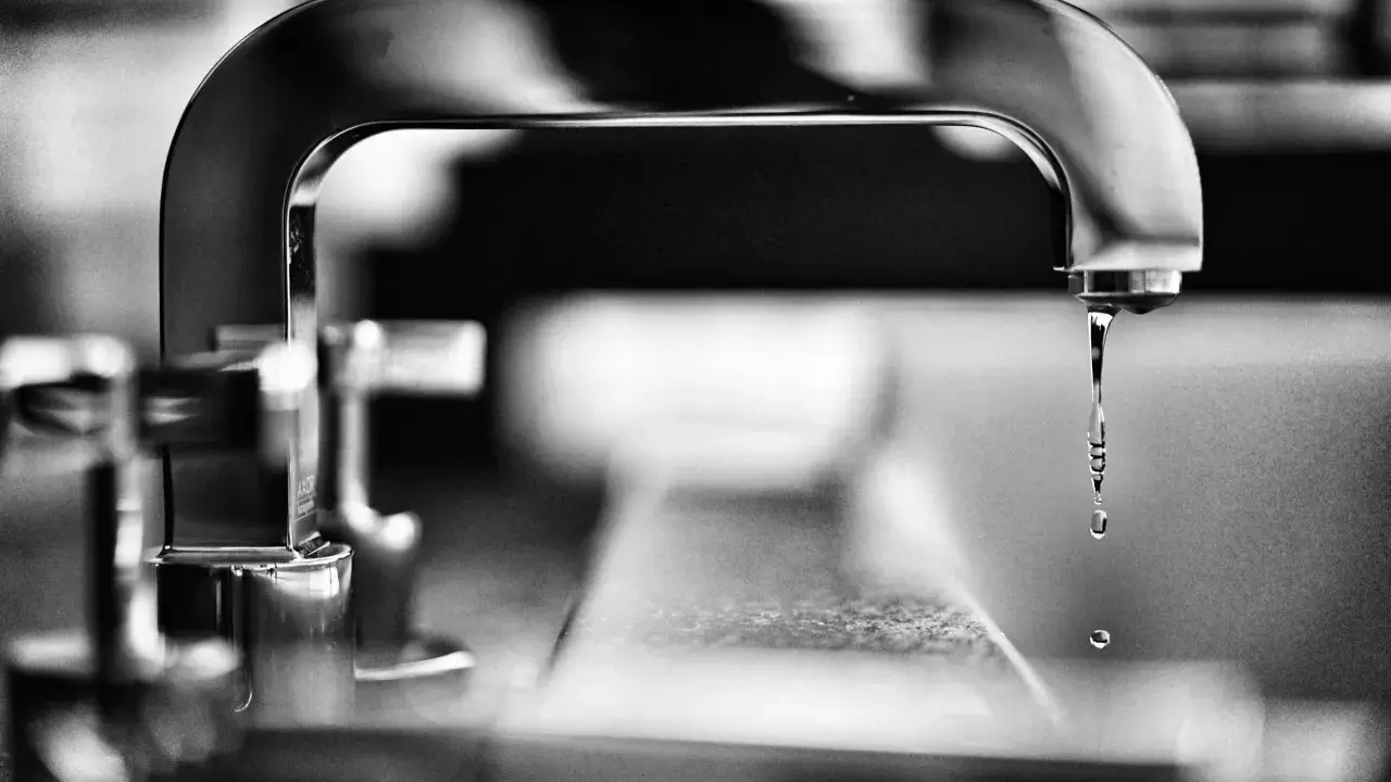 Gouttes d'eau tombant d'un robinet, évoquant la dureté de l'eau à Lyon.