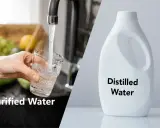 Comparaison visuelle : eau du robinet purifiée dans un verre et une bouteille d'eau distillée. Comprendre la différence eau distillée et déminéralisée.