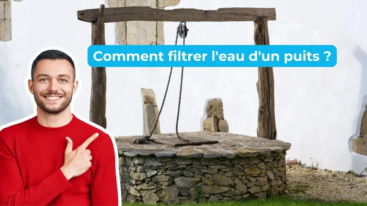 Un homme souriant pointe vers un vieux puit en pierre. Le texte 